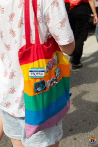 Una borsa arcobaleno con i pronomi he/him